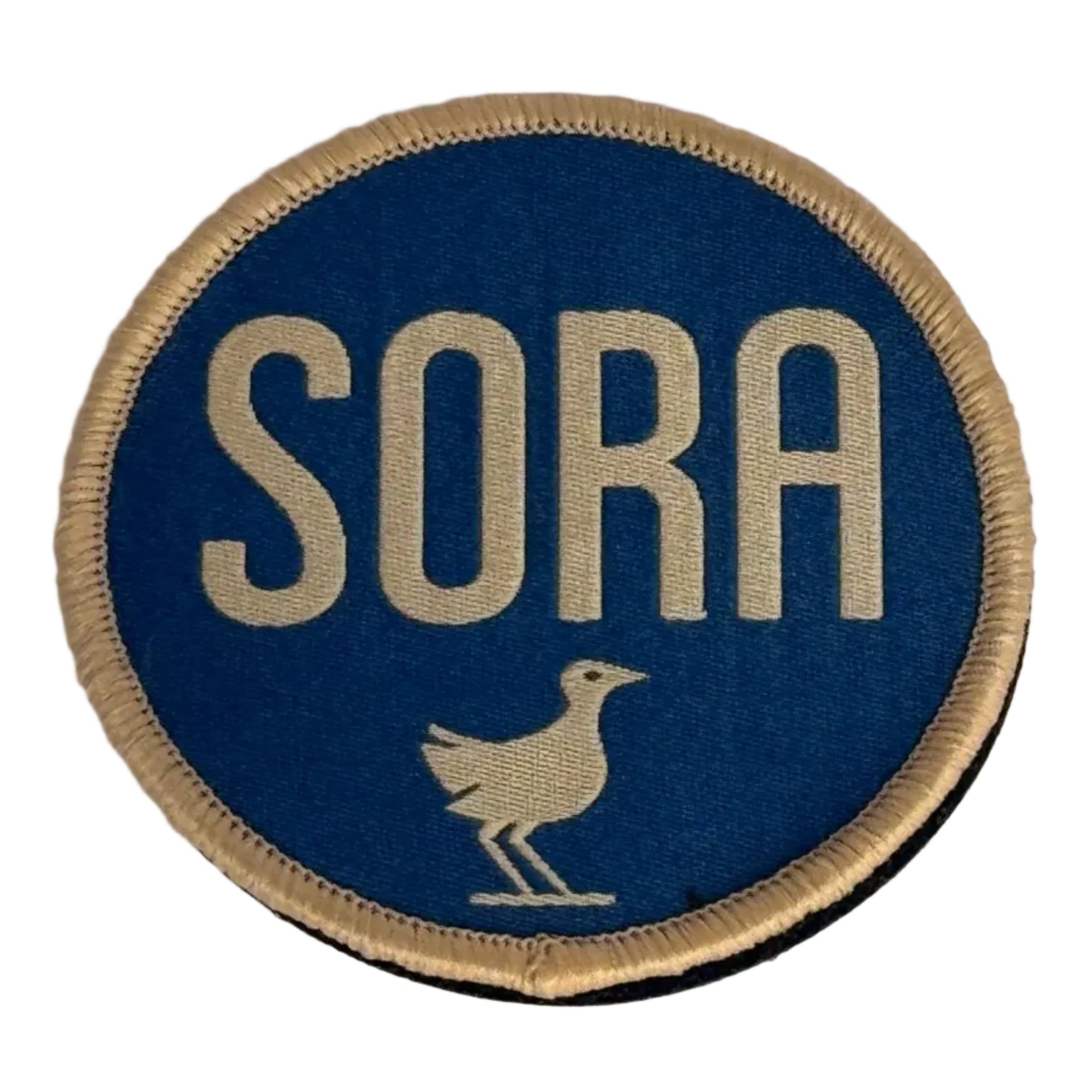 Round blue patch with 'SORA' text and a bird illustration on a gray background